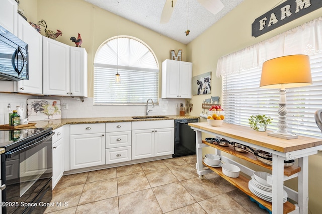 1924 Elderberry Ct NE, Palm Bay, FL 32905 - kitchen featuring a sink, black appliances, vaulted ceiling, tasteful backsplash, and white cabinets