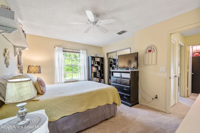 1924 Elderberry Ct NE, Palm Bay, FL 32905 - bedroom featuring light colored carpet, a textured ceiling, baseboards, and a ceiling fan