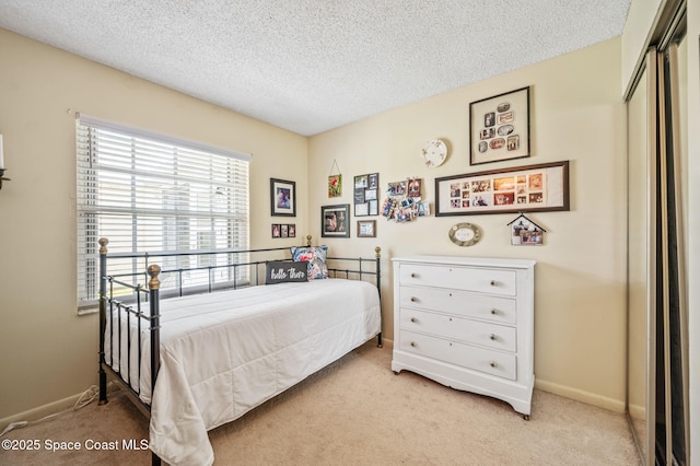 1924 Elderberry Ct NE, Palm Bay, FL 32905 - bedroom featuring light colored carpet, a textured ceiling, a closet, and baseboards