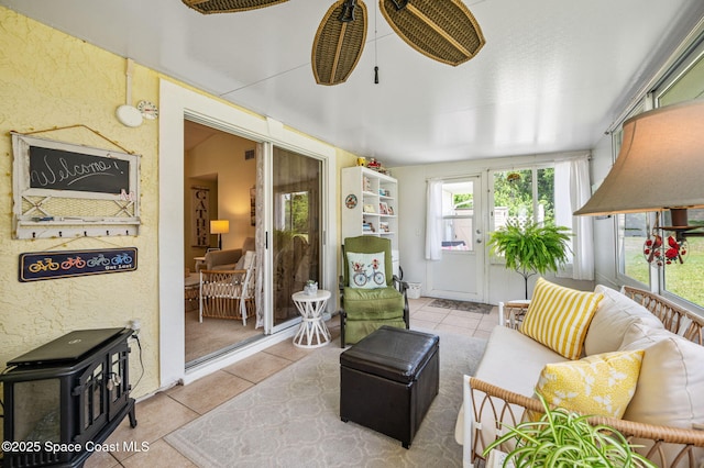 1924 Elderberry Ct NE, Palm Bay, FL 32905 - sunroom with tile patterned flooring, a wood stove, and a textured wall