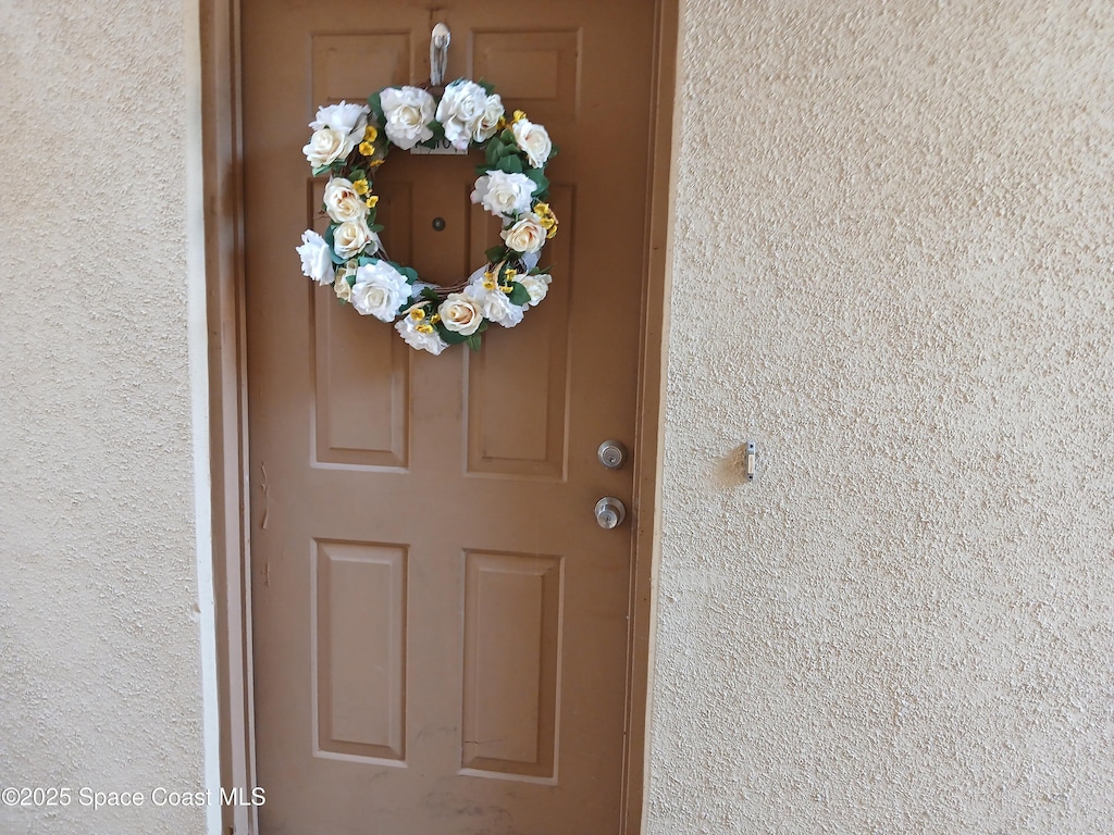 1600 Sunny Brook Ln NE Unit F108, Palm Bay, FL 32905 - view of exterior entry with stucco siding