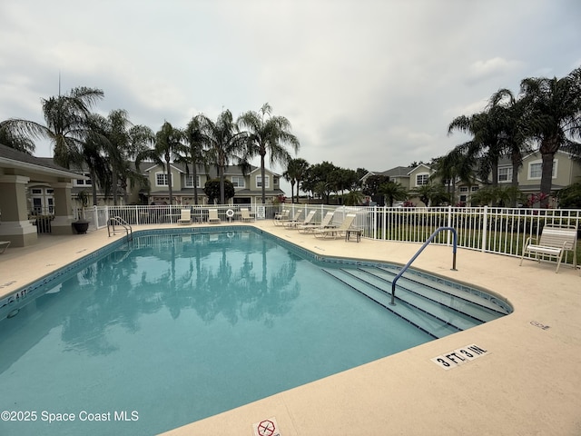 601 Trotter Ln Unit 102, Melbourne, FL 32940 - community pool featuring a patio area and a residential view