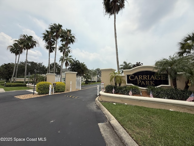 601 Trotter Ln Unit 102, Melbourne, FL 32940 - view of asphalt road with a gate