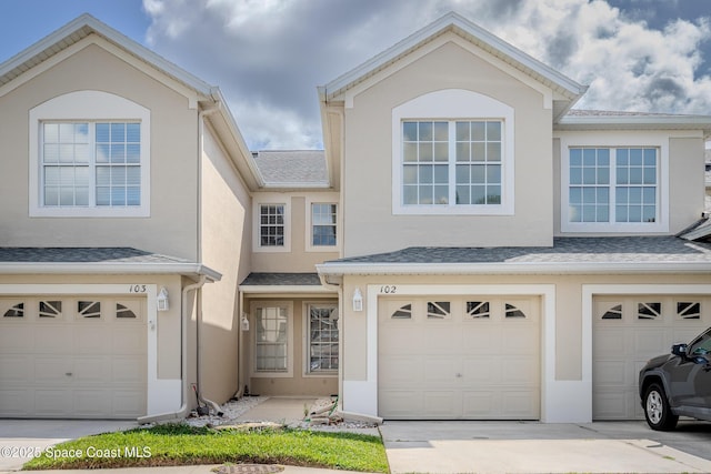 601 Trotter Ln Unit 102, Melbourne, FL 32940 - view of front of house featuring an attached garage, stucco siding, and driveway