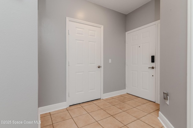 601 Trotter Ln Unit 102, Melbourne, FL 32940 - foyer with baseboards and light tile patterned floors