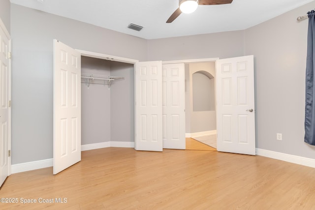 601 Trotter Ln Unit 102, Melbourne, FL 32940 - unfurnished bedroom featuring light wood-style flooring, baseboards, a closet, and ceiling fan