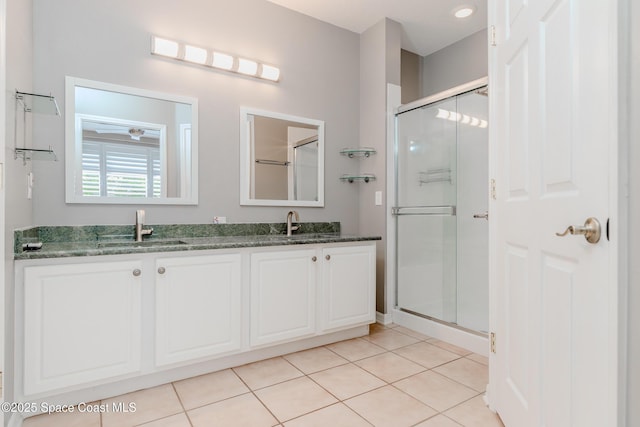 601 Trotter Ln Unit 102, Melbourne, FL 32940 - bathroom featuring double vanity, a stall shower, and tile patterned floors