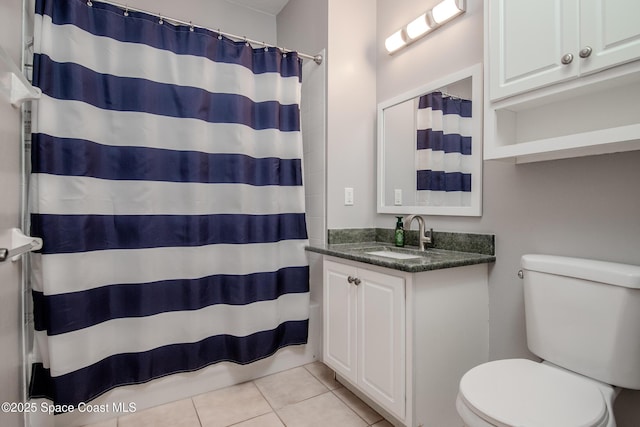 601 Trotter Ln Unit 102, Melbourne, FL 32940 - full bathroom featuring toilet, tile patterned flooring, vanity, and a shower with shower curtain