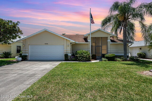 1444 Patriot Dr, Melbourne, FL 32940 - view of front of property with an attached garage, a yard, stucco siding, and concrete driveway