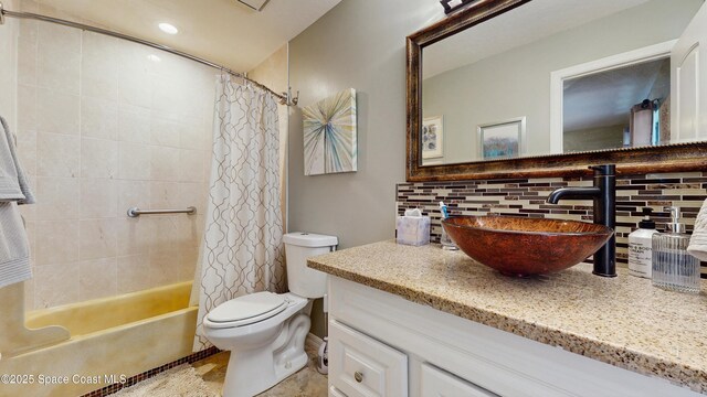 2180 Dumas St, Merritt Island, FL 32952 - bathroom featuring decorative backsplash, vanity, toilet, and shower / tub combo