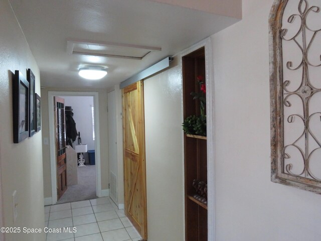 4535 Moon Rd, Titusville, FL 32780 - hall featuring light tile patterned floors, baseboards, and attic access