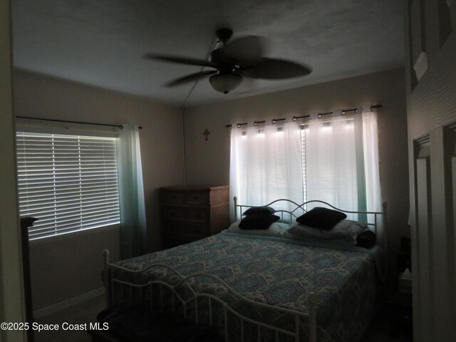 4535 Moon Rd, Titusville, FL 32780 - bedroom featuring multiple windows, baseboards, and ceiling fan