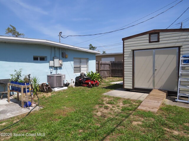 4535 Moon Rd, Titusville, FL 32780 - view of yard with a storage shed, central AC unit, and an outbuilding