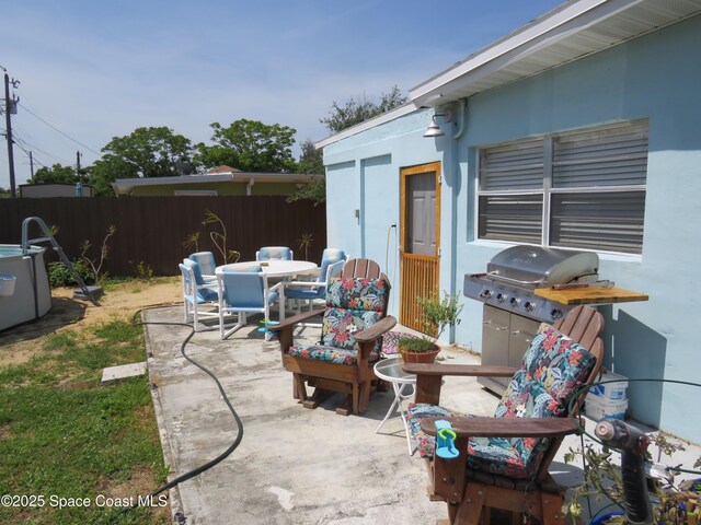 4535 Moon Rd, Titusville, FL 32780 - view of patio featuring fence, outdoor dining space, and area for grilling