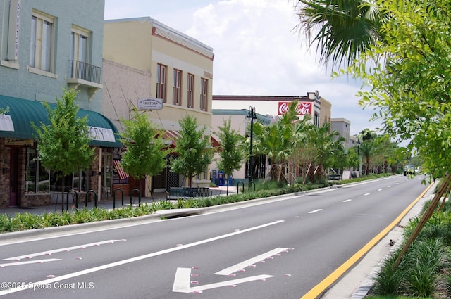 4535 Moon Rd, Titusville, FL 32780 - view of asphalt street featuring curbs, sidewalks, and street lighting