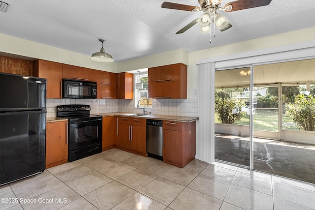 7034 Bayfront Rd, Cocoa, FL 32927 - kitchen featuring black appliances, a sink, light countertops, backsplash, and ceiling fan