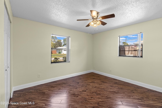 7034 Bayfront Rd, Cocoa, FL 32927 - spare room featuring wood finished floors, plenty of natural light, a ceiling fan, a textured ceiling, and baseboards