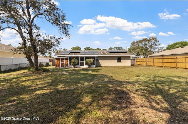 7034 Bayfront Rd, Cocoa, FL 32927 - back of house with a sunroom and roof mounted solar panels