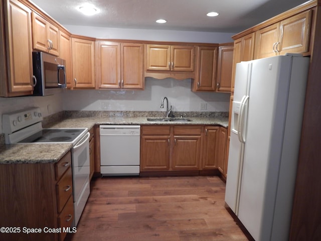865 Greenwood Manor Cir Unit 5-F, West Melbourne, FL 32904 - kitchen with white appliances, a sink, wood finished floors, recessed lighting, and brown cabinets