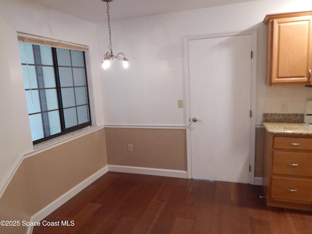 865 Greenwood Manor Cir Unit 5-F, West Melbourne, FL 32904 - unfurnished dining area featuring dark wood-style floors, baseboards, and a chandelier