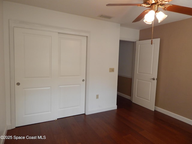 865 Greenwood Manor Cir Unit 5-F, West Melbourne, FL 32904 - unfurnished bedroom with wood finished floors, baseboards, a closet, and ceiling fan