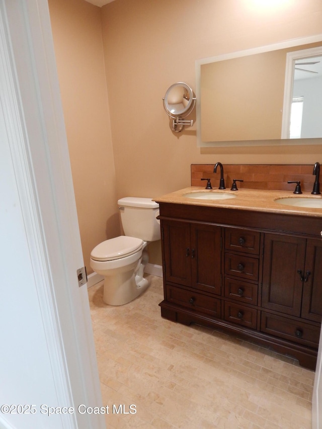 865 Greenwood Manor Cir Unit 5-F, West Melbourne, FL 32904 - bathroom featuring toilet, double vanity, and baseboards