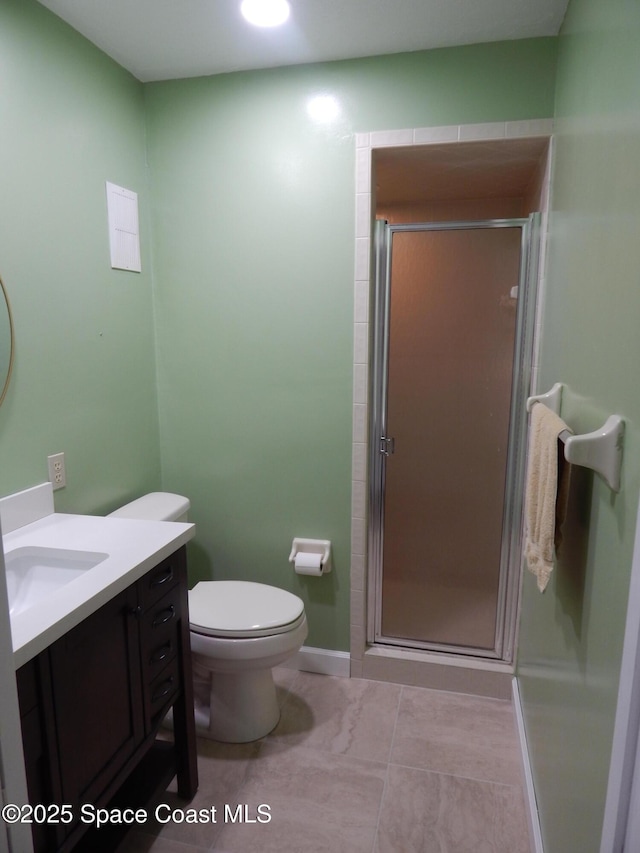 865 Greenwood Manor Cir Unit 5-F, West Melbourne, FL 32904 - bathroom with a stall shower, vanity, tile patterned floors, toilet, and baseboards