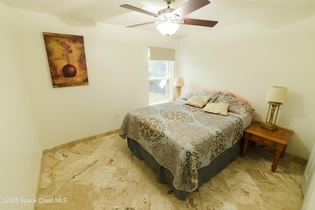 bedroom with ceiling fan and baseboards