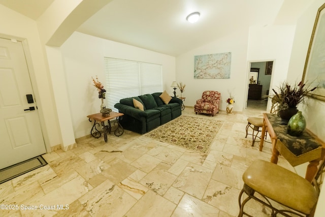 living room featuring lofted ceiling and arched walkways