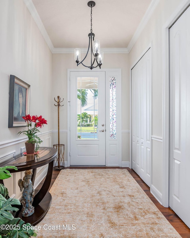 508 Lorelei Ave, Melbourne, FL 32901 - entrance foyer featuring a chandelier, dark wood-type flooring, and ornamental molding