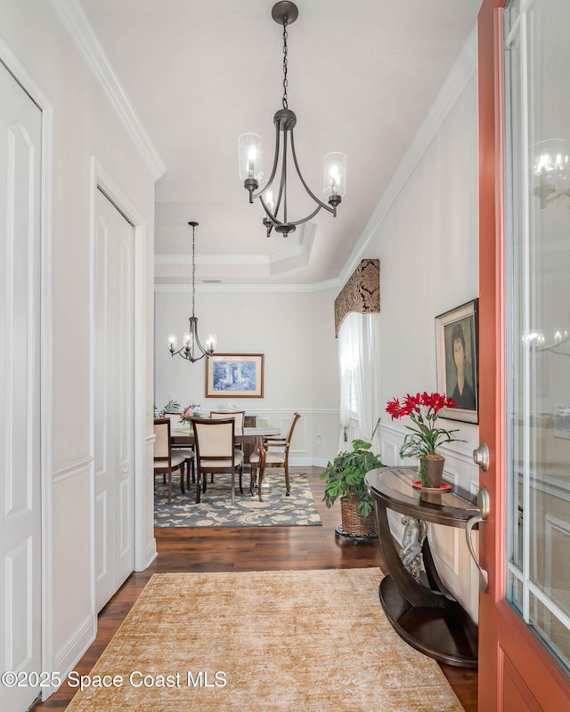 508 Lorelei Ave, Melbourne, FL 32901 - dining space featuring a chandelier, crown molding, dark wood-type flooring, and a raised ceiling