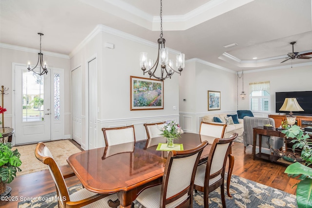 508 Lorelei Ave, Melbourne, FL 32901 - dining area with a raised ceiling, a chandelier, wood finished floors, crown molding, and wainscoting