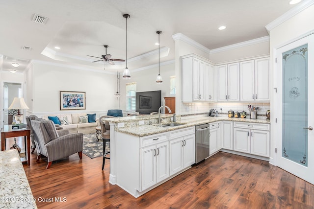508 Lorelei Ave, Melbourne, FL 32901 - kitchen with a sink, dishwasher, open floor plan, a peninsula, and white cabinets