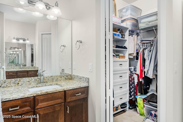 508 Lorelei Ave, Melbourne, FL 32901 - bathroom featuring vanity, a spacious closet, and tile patterned flooring