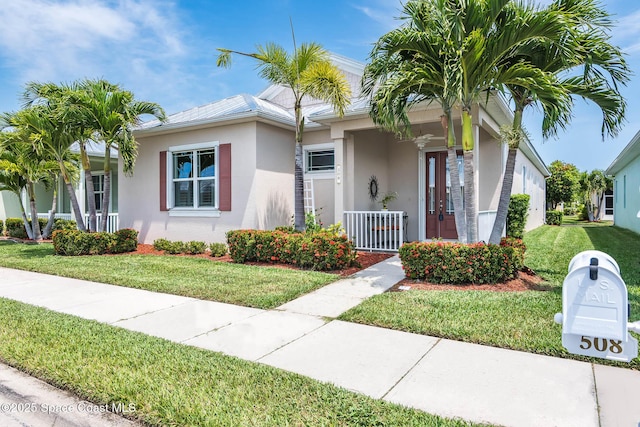 508 Lorelei Ave, Melbourne, FL 32901 - single story home with stucco siding, a front lawn, and covered porch