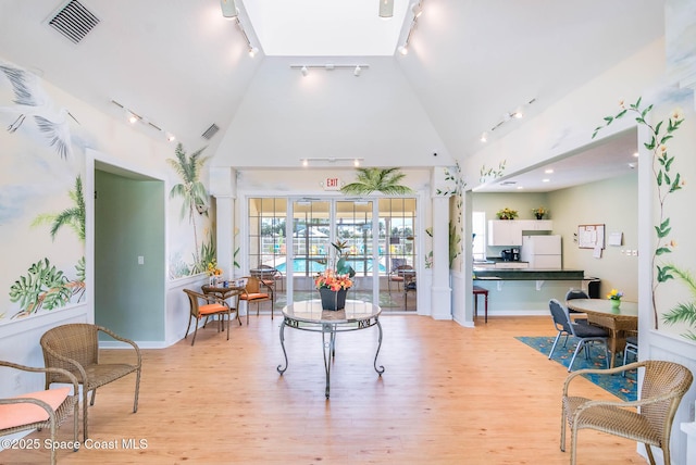 508 Lorelei Ave, Melbourne, FL 32901 - living room featuring track lighting, light wood-style flooring, and high vaulted ceiling