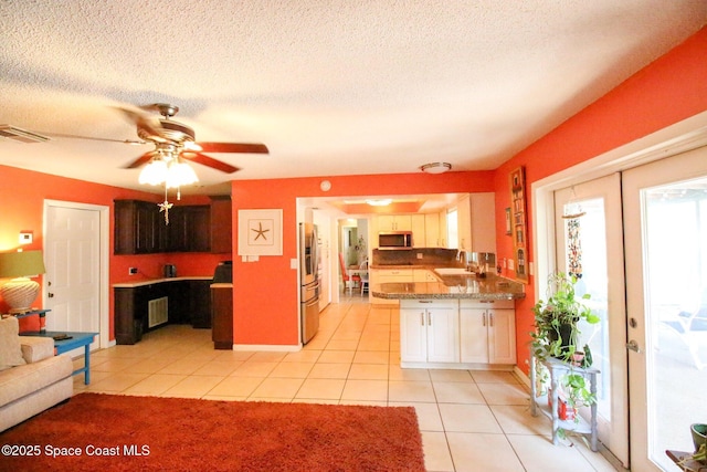 311 Clayton Ave, Melbourne, FL 32901 - kitchen featuring appliances with stainless steel finishes, a sink, light tile patterned flooring, a peninsula, and ceiling fan