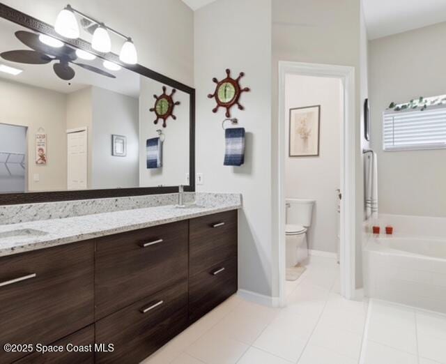 1932 Laramie Cir, Melbourne, FL 32940 - bathroom with double vanity, a garden tub, tile patterned floors, and toilet