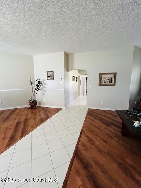 1932 Laramie Cir, Melbourne, FL 32940 - entryway featuring arched walkways, a textured ceiling, and wood finished floors