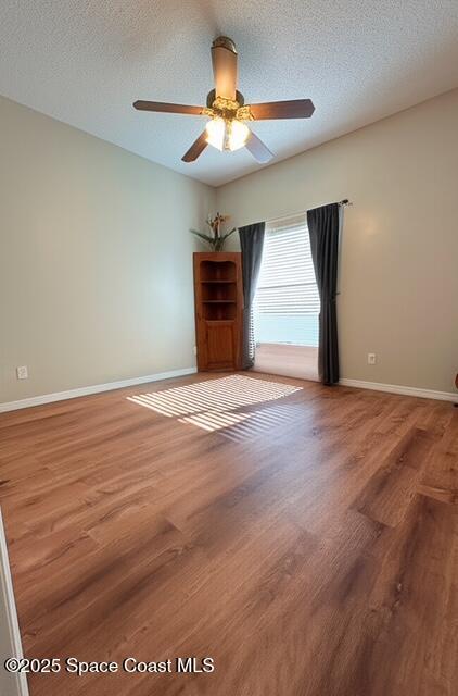 1932 Laramie Cir, Melbourne, FL 32940 - empty room featuring wood finished floors, baseboards, ceiling fan, and a textured ceiling