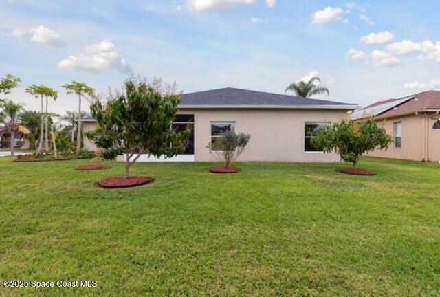 1932 Laramie Cir, Melbourne, FL 32940 - back of property with stucco siding and a yard
