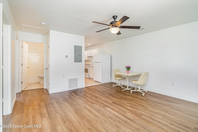 1230 Fern St Unit 1230 & 1232, Cocoa, FL 32922 - dining space featuring light wood-style flooring, ceiling fan, electric panel, and attic access