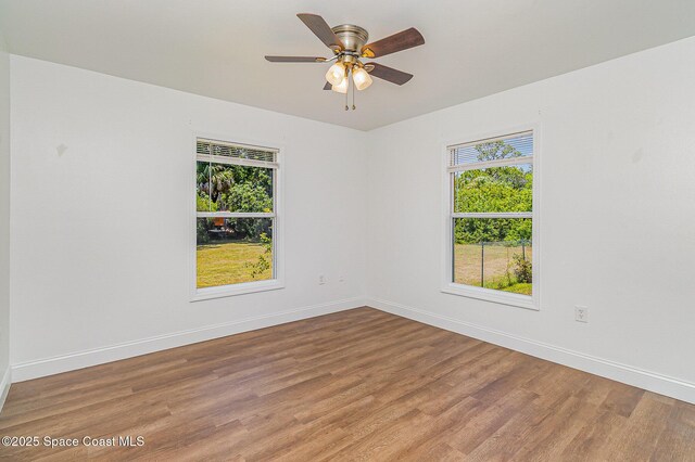 1230 Fern St Unit 1230 & 1232, Cocoa, FL 32922 - empty room featuring plenty of natural light, light wood-style floors, and a ceiling fan