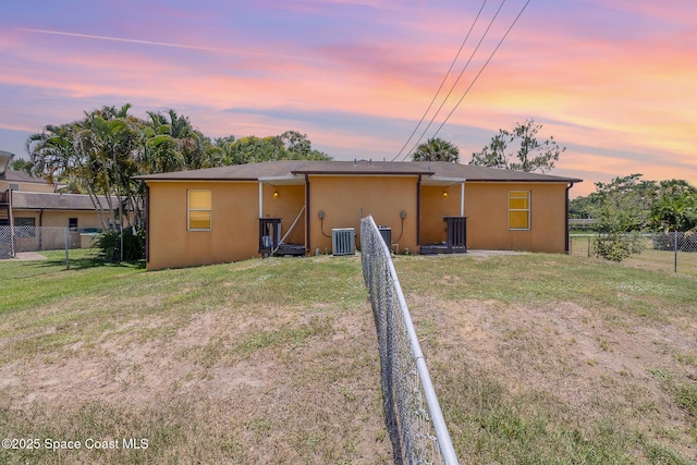 1230 Fern St Unit 1230 & 1232, Cocoa, FL 32922 - back of property at dusk featuring stucco siding and a fenced backyard