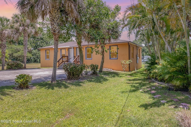 1230 Fern St Unit 1230 & 1232, Cocoa, FL 32922 - view of front of home with stucco siding and a front lawn