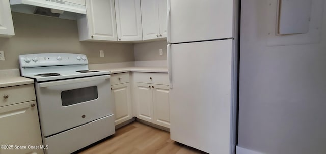 3143 Sir Hamilton Cir Unit 12, Titusville, FL 32780 - kitchen with white appliances, under cabinet range hood, light countertops, and light wood finished floors