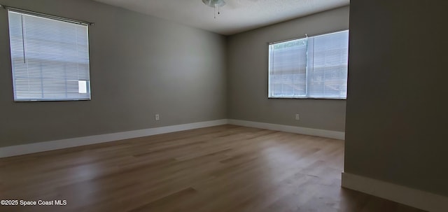3143 Sir Hamilton Cir Unit 12, Titusville, FL 32780 - empty room with wood finished floors, baseboards, and a ceiling fan