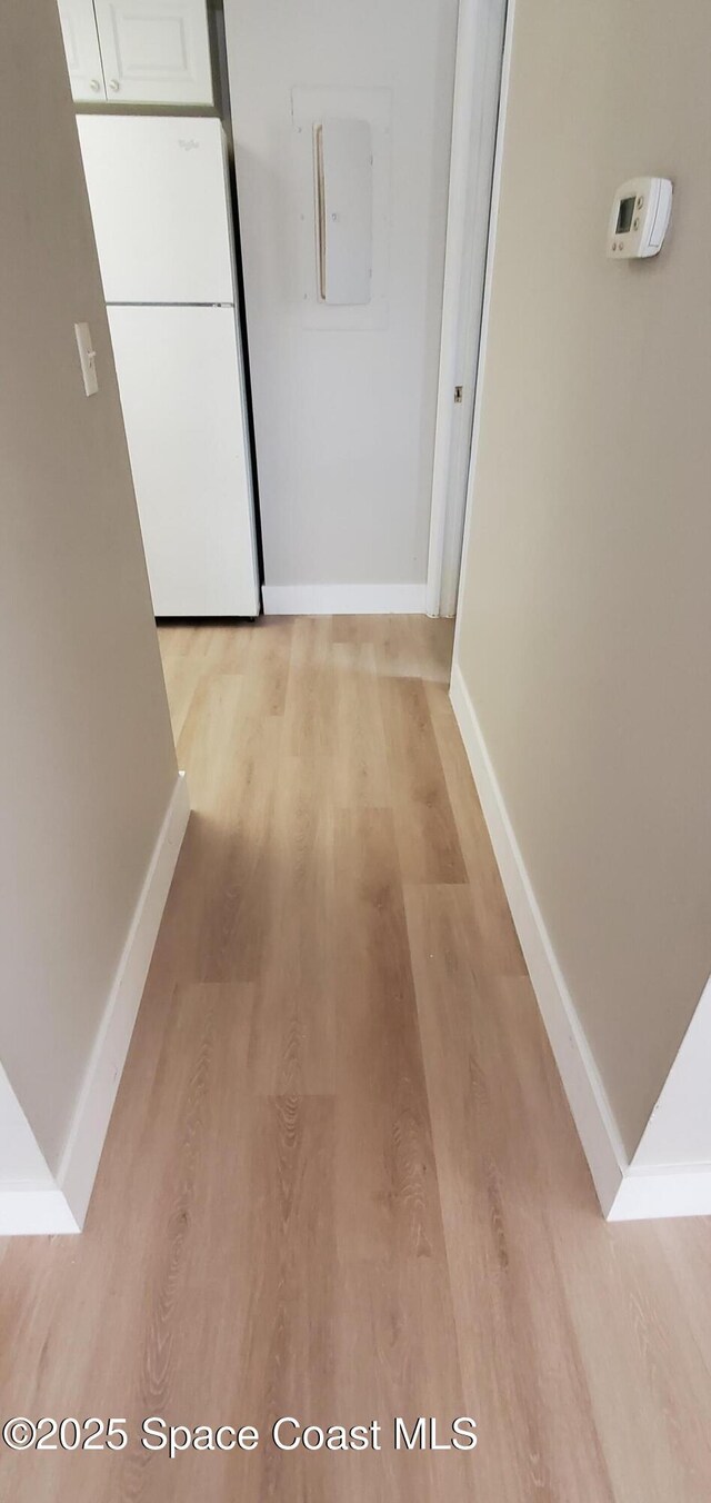 3143 Sir Hamilton Cir Unit 12, Titusville, FL 32780 - hallway featuring light wood-style flooring and baseboards