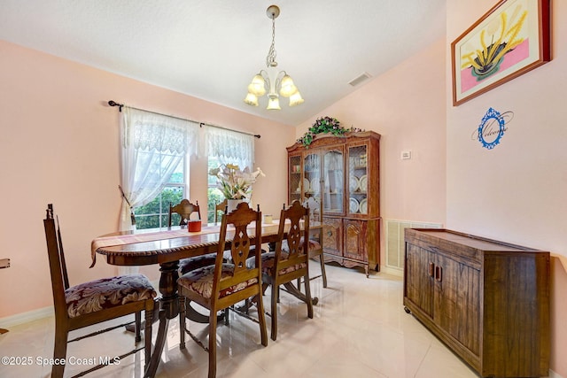 427 Falls Church St SW, Palm Bay, FL 32908 - dining room featuring a chandelier, baseboards, light tile patterned floors, and vaulted ceiling