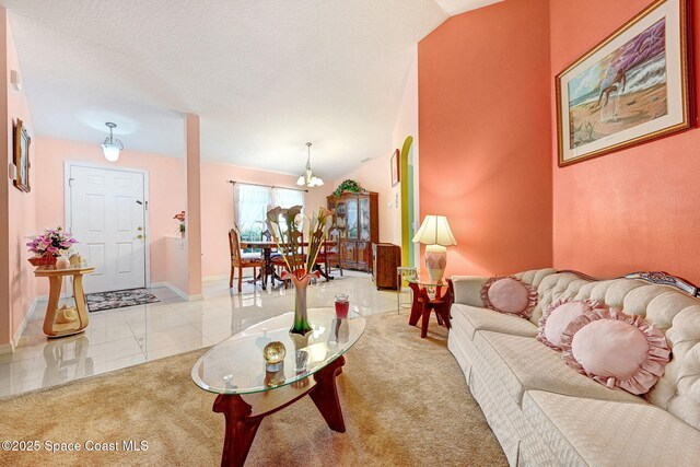 427 Falls Church St SW, Palm Bay, FL 32908 - living area with carpet floors, baseboards, tile patterned flooring, and a chandelier